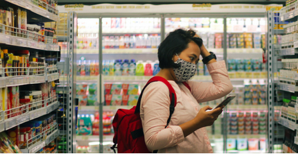 lady in face mask shopping in grocery store
